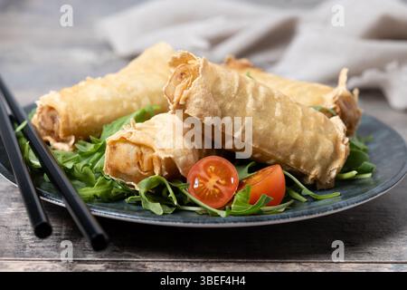 Crispy vegetables spring Rolls on wooden table Stock Photo