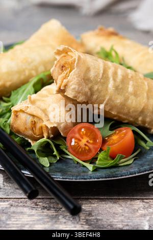 Crispy vegetables spring Rolls on wooden table Stock Photo
