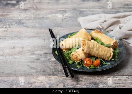 Crispy vegetables spring Rolls on wooden table Stock Photo