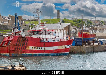 Macduff Aberdeenshire Scotland red scalloper vessel moored or berthed in the harbour Stock Photo
