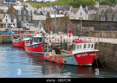 Macduff Aberdeenshire Scotland three small red fishing boats moored or berthed in the harbour Stock Photo