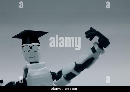 Cute futuristic little robot wearing a graduation cap, robot, cute, futuristic, graduation cap Stock Photo