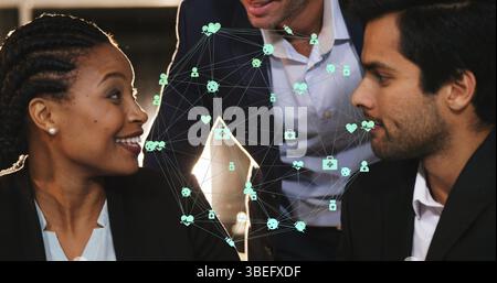 Globe of digital icons over three diverse male and female office colleagues discussing at office Stock Photo