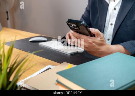 Close-up of a professional using a mobile phone — digital tools in corporate life Stock Photo