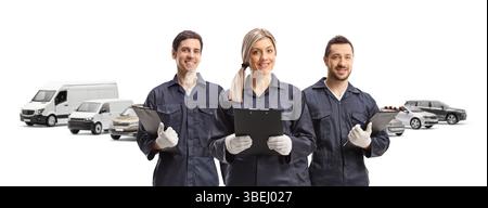 Team of mechanics holding working tools at a car park isolated on white background Stock Photo