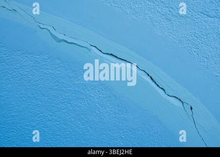 Blue wall texture background. Crack wall texture. Cracked concrete wall covered with cement surface as background. Stock Photo