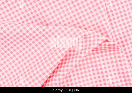 Wrinkled classic pink color plaid fabric or tablecloth background. Stock Photo