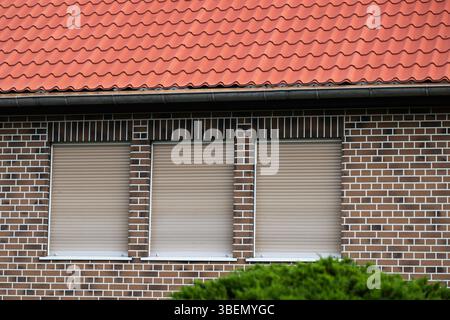 Brown roller shutters on a house Stock Photo