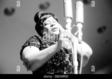 Fitzgerald performing at the Helsinki Culture Hall in Finland in April 1963. Ella Jane Fitzgerald (April 25, 1917 – June 15, 1996) was an American singer, songwriter and composer, sometimes referred to as the "First Lady of Song", "Queen of Jazz", and "Lady Ella". She was noted for her purity of tone, impeccable diction, phrasing, timing, intonation, absolute pitch, and a "horn-like" improvisational ability. Stock Photo