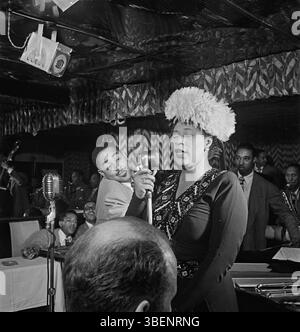 Ella Fitzgerald performing with Dizzy Gillespie, Ray Brown, Milt (Milton) Jackson, and Timmie Rosenkrantz,at the Club Downbeat, New York in Sept. 1947. Ella Jane Fitzgerald (April 25, 1917 – June 15, 1996) was an American singer, songwriter and composer, sometimes referred to as the "First Lady of Song", "Queen of Jazz", and "Lady Ella". She was noted for her purity of tone, impeccable diction, phrasing, timing, intonation, absolute pitch, and a "horn-like" improvisational ability. Stock Photo
