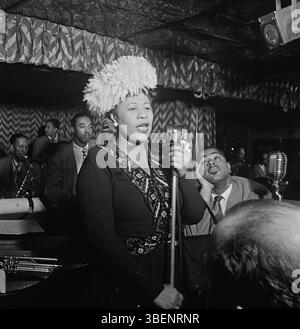 Ella Fitzgerald performing with Dizzy Gillespie, Ray Brown, Milt (Milton) Jackson, and Timmie Rosenkrantz,at the Club Downbeat, New York in Sept. 1947. Ella Jane Fitzgerald (April 25, 1917 – June 15, 1996) was an American singer, songwriter and composer, sometimes referred to as the "First Lady of Song", "Queen of Jazz", and "Lady Ella". She was noted for her purity of tone, impeccable diction, phrasing, timing, intonation, absolute pitch, and a "horn-like" improvisational ability. Stock Photo