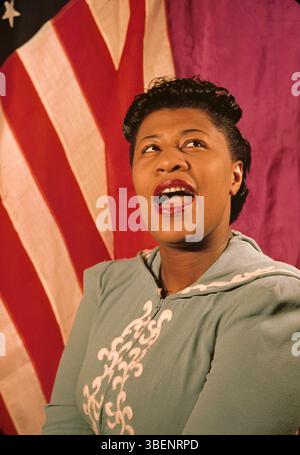 Kodachrome photo of Ella Fitzgerald taken by Carl Van Vechten. Ella Jane Fitzgerald (April 25, 1917 – June 15, 1996) was an American singer, songwriter and composer, sometimes referred to as the "First Lady of Song", "Queen of Jazz", and "Lady Ella". She was noted for her purity of tone, impeccable diction, phrasing, timing, intonation, absolute pitch, and a "horn-like" improvisational ability. Stock Photo