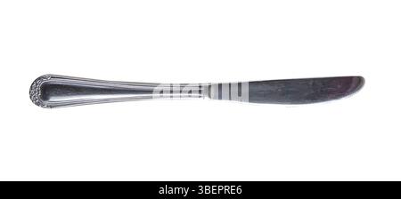 Old silver butter knife isolated on white background. Laying horizontally. Stock Photo