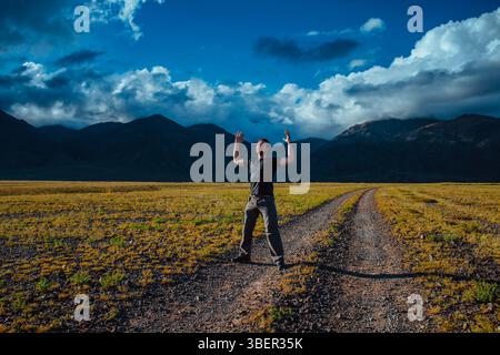 Young strong man posing in the mountains, freedom and success concept Stock Photo