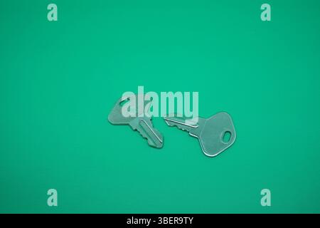 Two pair stainless lock isolated on green. Stock Photo