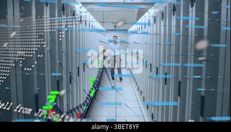 Financial data processing and world map over caucasian male engineer walking in computer server room Stock Photo