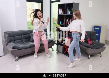 Two close friends are enjoying a lighthearted and playful moment indoors, showcasing their deep friendship and pure joy Stock Photo