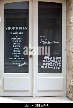 List of Shop Rules written on door entrance to InkStation tattoo studio shop, Guimaraes, Portugal, Europe Stock Photo