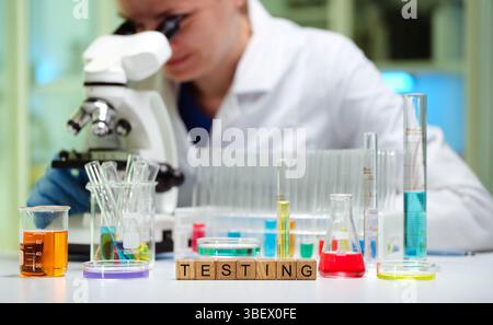 Conducting advanced scientific tests in a modern lab with microscopes and various chemicals Stock Photo
