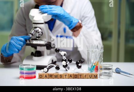 A scientist is meticulously examining various samples under a microscope in a laboratory setting Stock Photo