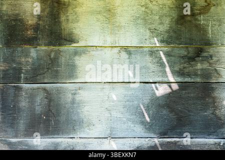 Old weathered wooden board wall surface texture with faded paint closeup as grunge background Stock Photo