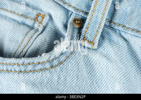 Macro fabric texture of cotton blue jeans. Pocket and thread stitching. Stock Photo