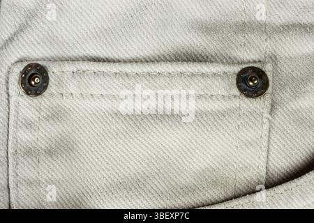 Macro Texture Beige Natural Denim. Metal Denim Tack Button. Stock Photo