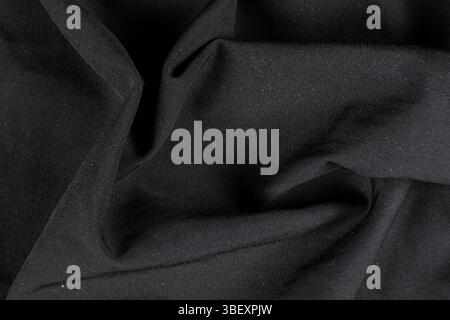 Old worn-out polyester and elastane fabric, pilling and frayed threads. Stock Photo