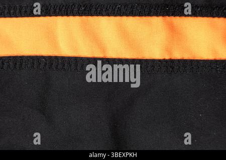 Old worn-out polyester and elastane fabric, pilling and frayed threads. Stock Photo