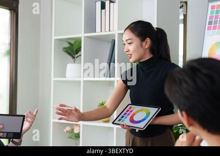 Presenting UX UI Concepts. A designer showcasing a digital design to the team. Stock Photo