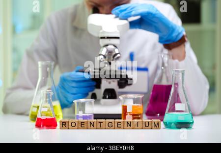 A dedicated scientist is analyzing samples with a microscope in a laboratory for research Stock Photo