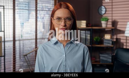 Business female woman businesswoman portrait serious calm girl looking at camera confident lady worker in office company posing working startup leader Stock Photo