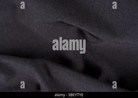 Old worn-out polyester and elastane fabric, pilling and frayed threads. Stock Photo
