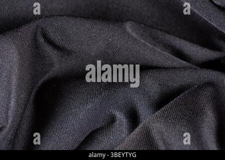 Old worn-out polyester and elastane fabric, pilling and frayed threads. Stock Photo