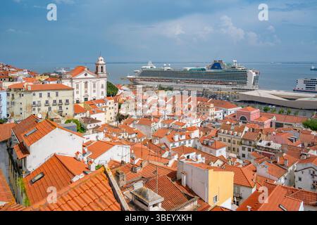 View of cruise ship in port and terrakotta rooftops in Alfama, Alfama District, Lisbon, Portugal, Europe Stock Photo