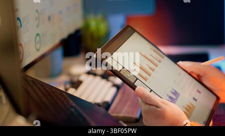 Digital Data Analytics Tablet Modern Office Workspace monitor display business professional using stylus analyze traffic financial charts digital tabl Stock Photo