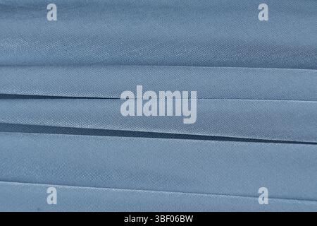 Soft Blue Fabric Background with Abstract Patterns and Empty Text Space. Stock Photo