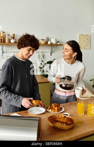 Couple enjoys a delightful breakfast while sharing smiles and warmth in their kitchen. Stock Photo