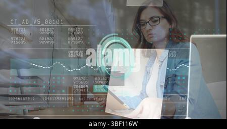 Image of data processing, file icons and clock over caucasian businesswoman at office Stock Photo
