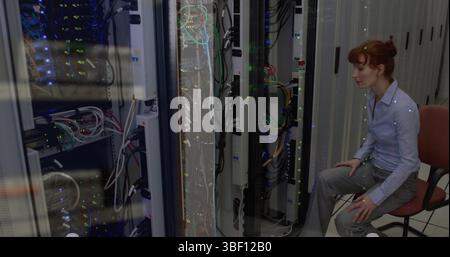 Image of data processing against caucasian female engineer working at server room Stock Photo