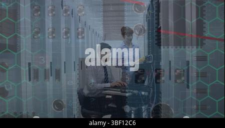 Microprocessor connections over caucasian male and female engineers working at server room Stock Photo