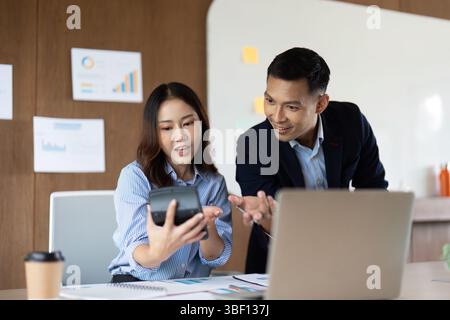 Digital Transformation in Business. Colleagues discussing data insights on a smartphone. Stock Photo