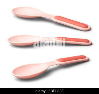 set of plastic baby spoons with shadows isolated white background, light pink spoons with reddish grip on handle, designed for safe feeding Stock Photo