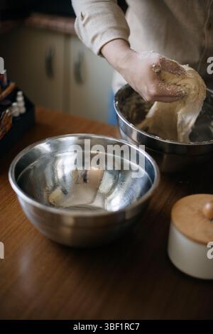 Fresh yeast dough with flour on a kitchen countertop Stock Photo - Alamy