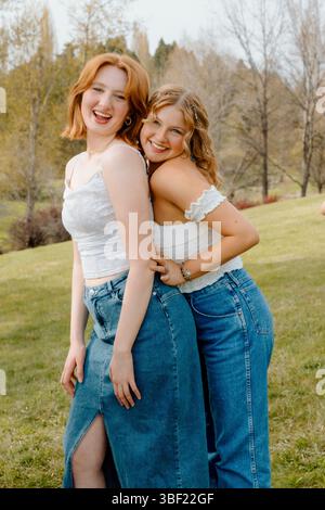 Two gen z college roommates embracing friendship on campus Stock Photo