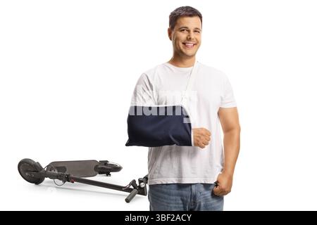 Young man with a broken arm wearing an arm splint, injured in a scooter accident isolated on white background Stock Photo