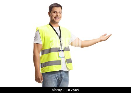 Young man in a reflective safety vest showing with hand isolated on white background Stock Photo