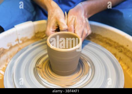 Pottering - creating a clay cup in process. Shot with a small GRIP Stock Photo