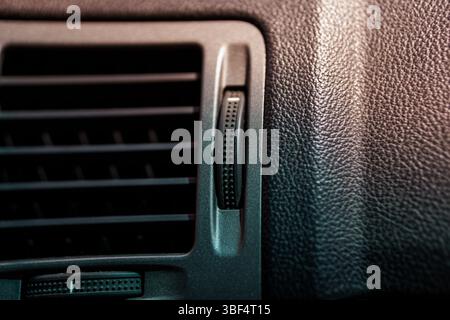 A detailed close-up shot showcases a car's air vent system nestled within luxurious black leather upholstery, highlighting the vehicle's modern design Stock Photo