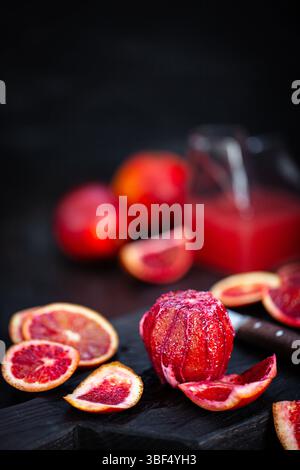 Fresh ripe red blood oranges (sicilian) on dark background Stock Photo